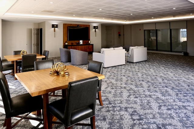 dining space featuring a tray ceiling, carpet, and recessed lighting