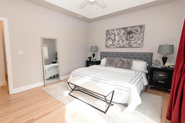 bedroom with baseboards, a ceiling fan, and wood finished floors