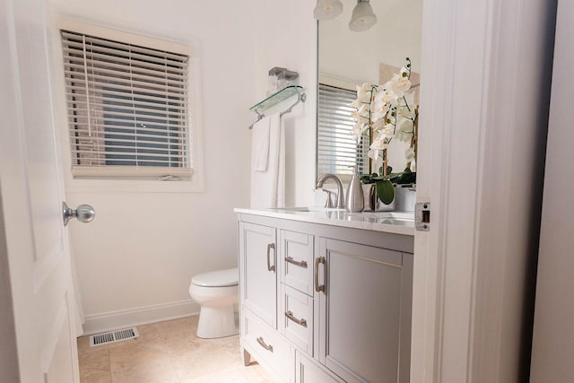bathroom featuring toilet, visible vents, baseboards, and vanity