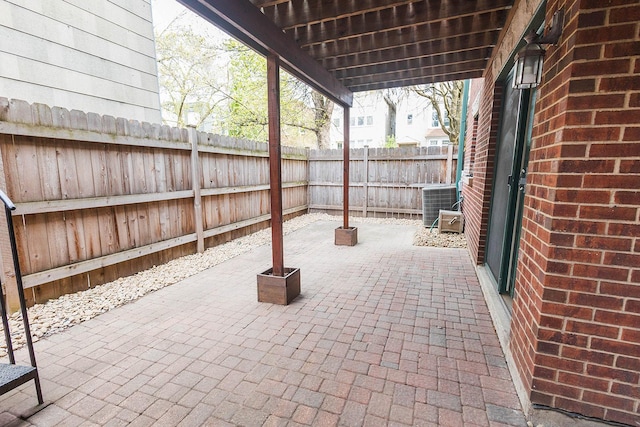 view of patio / terrace featuring cooling unit and a fenced backyard