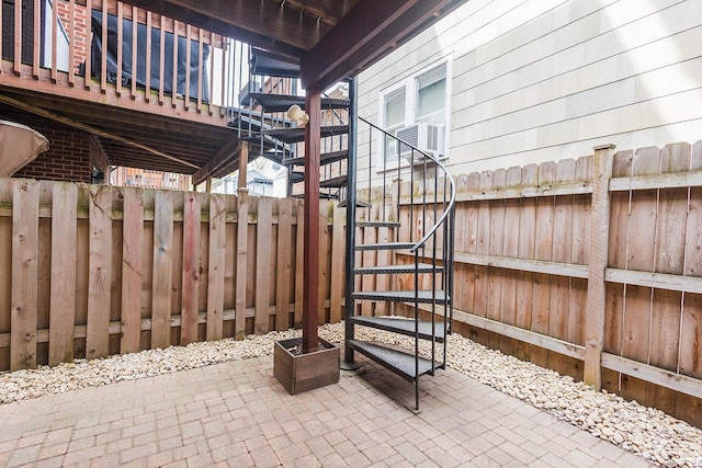 view of patio with stairway, fence, and cooling unit