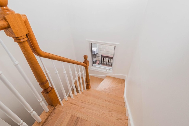 staircase with wood finished floors