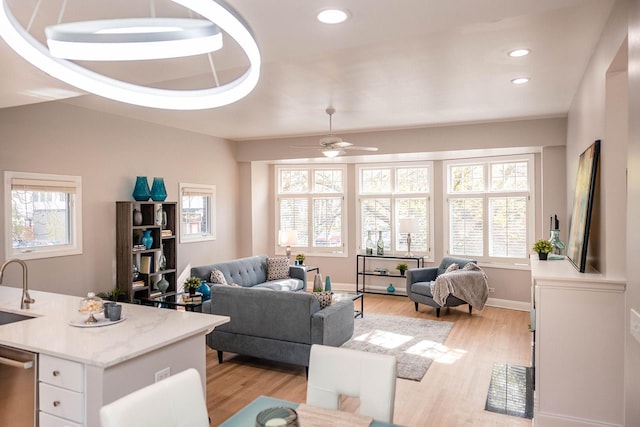living area featuring a ceiling fan, recessed lighting, and light wood-type flooring