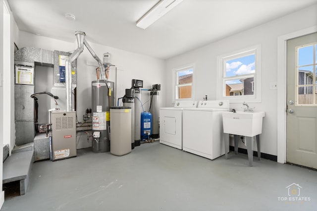 laundry room featuring separate washer and dryer, heating unit, water heater, and laundry area
