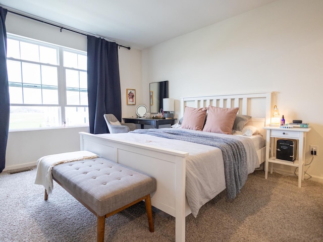 bedroom featuring baseboards, visible vents, and carpet