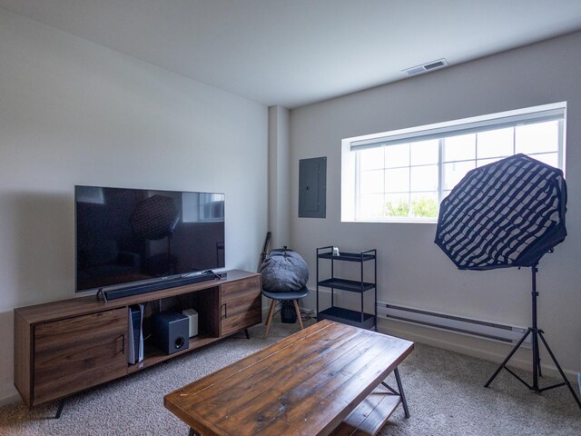 living room with baseboard heating, electric panel, carpet floors, baseboards, and visible vents