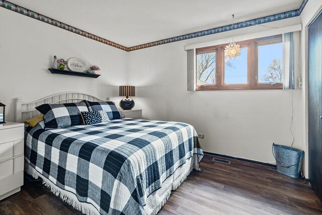 bedroom with visible vents and wood finished floors