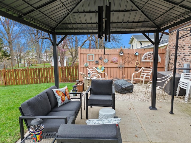 view of patio featuring a gazebo, an outdoor living space, and a fenced backyard