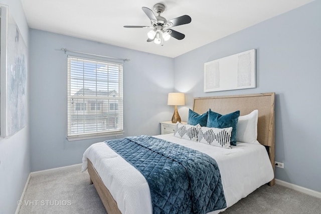 carpeted bedroom with baseboards and a ceiling fan