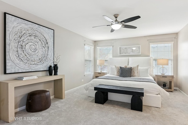 carpeted bedroom with baseboards and a ceiling fan