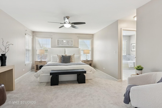 carpeted bedroom with connected bathroom, baseboards, and a ceiling fan