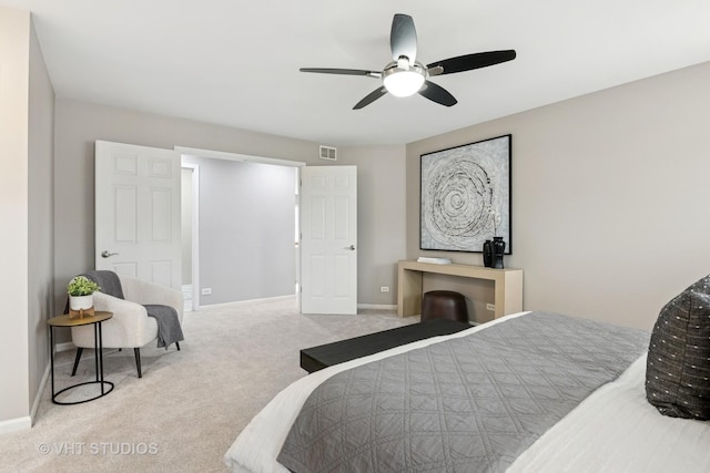 carpeted bedroom with visible vents, a ceiling fan, and baseboards