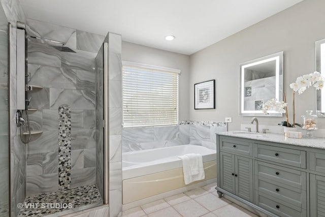 bathroom featuring a bath, vanity, tile patterned flooring, and a tile shower