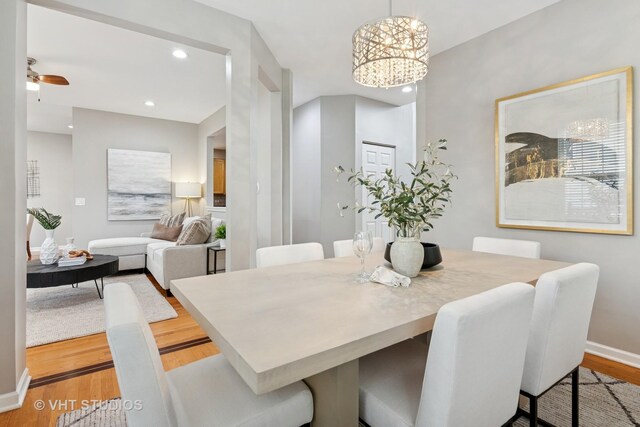 dining space featuring recessed lighting, baseboards, an inviting chandelier, and light wood-style flooring