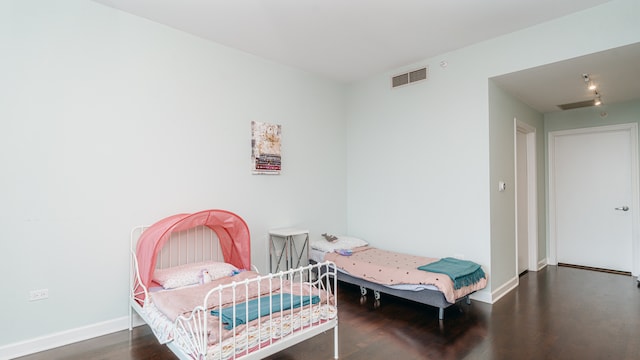 bedroom featuring wood finished floors and baseboards