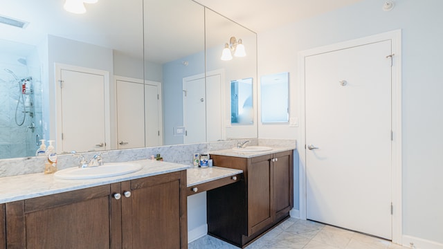 full bathroom with a shower stall, vanity, and marble finish flooring