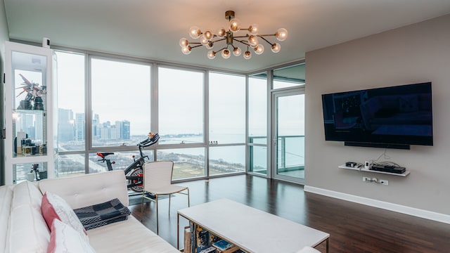 living area featuring a chandelier, healthy amount of natural light, and a wall of windows