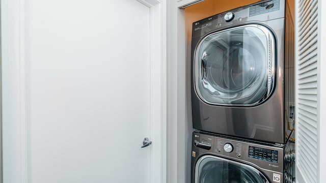 laundry area featuring stacked washer / dryer