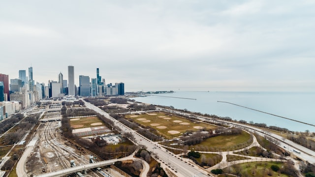aerial view of a main thoroughfare, a skyline view, and a nearby body of water