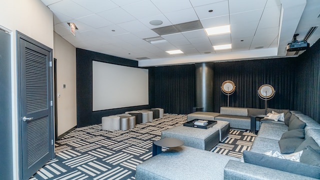 home theater with carpet and a paneled ceiling