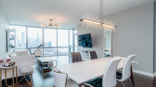 dining area featuring a chandelier, dark wood finished floors, floor to ceiling windows, and baseboards