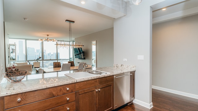 kitchen with dishwasher, dark wood-style flooring, a sink, light stone countertops, and baseboards