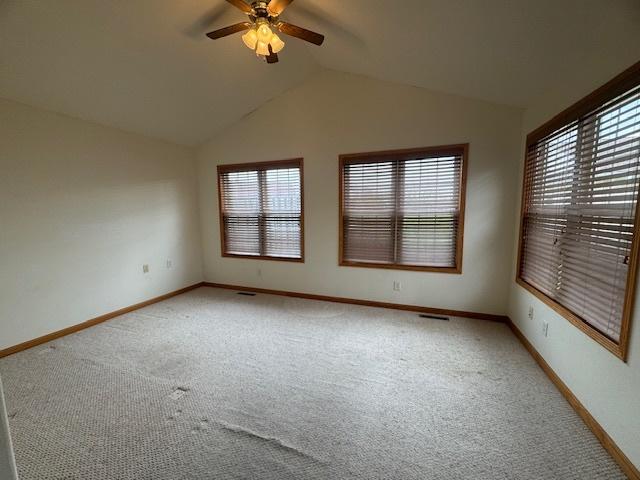 unfurnished room featuring light carpet, ceiling fan, and a healthy amount of sunlight