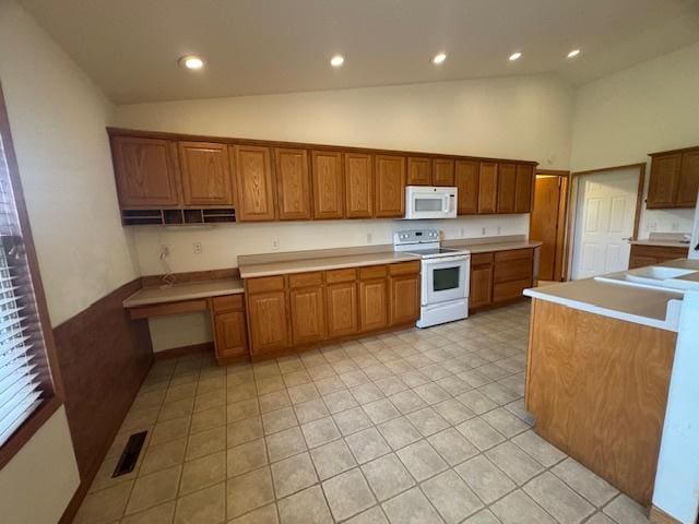 kitchen featuring high vaulted ceiling, brown cabinetry, white appliances, visible vents, and recessed lighting