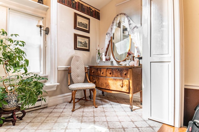 105 S High St, Galena, IL 61036 - living area featuring a baseboard heating unit, tile patterned floors, and baseboards