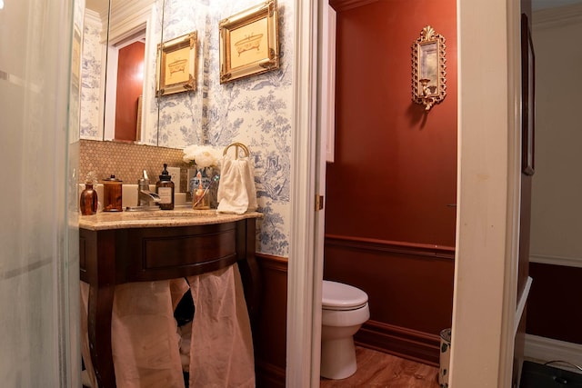 105 S High St, Galena, IL 61036 - bathroom with wallpapered walls, wood finished floors, vanity, and toilet