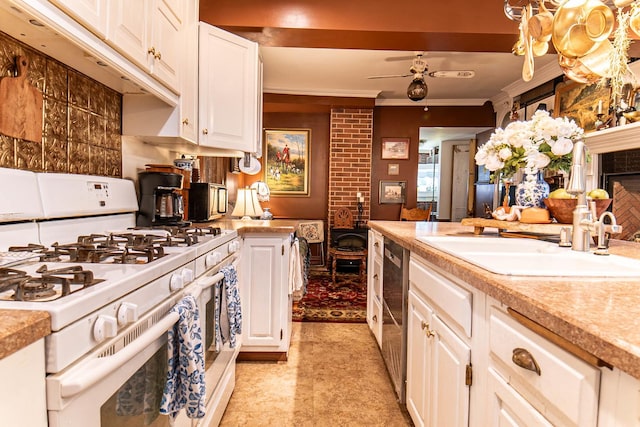 105 S High St, Galena, IL 61036 - kitchen with white cabinets, light countertops, white range with gas stovetop, and ornamental molding
