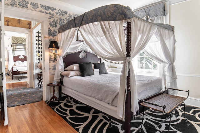 105 S High St, Galena, IL 61036 - bedroom with baseboards, wood finished floors, and ornamental molding