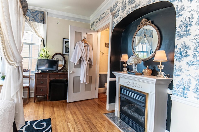 105 S High St, Galena, IL 61036 - interior space featuring a fireplace with flush hearth, wallpapered walls, wood finished floors, and crown molding