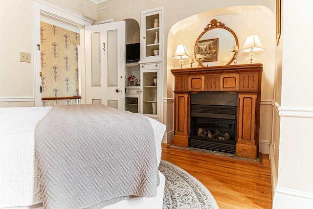 105 S High St, Galena, IL 61036 - bedroom with a fireplace with flush hearth, wood finished floors, and ornamental molding