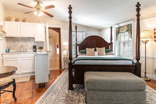 105 S High St, Galena, IL 61036 - bedroom featuring vaulted ceiling, hardwood / wood-style floors, and a sink