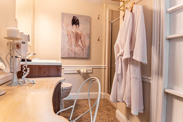105 S High St, Galena, IL 61036 - bathroom featuring a shower stall, toilet, vanity, and baseboards
