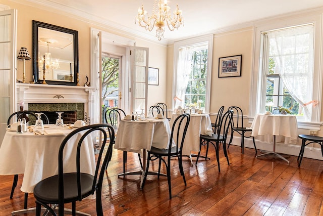 105 S High St, Galena, IL 61036 - dining room featuring wood-type flooring, ornamental molding, a chandelier, and plenty of natural light