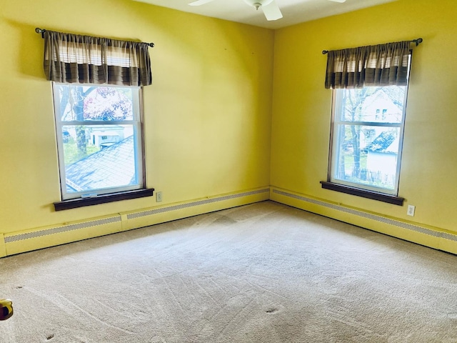 empty room with a ceiling fan, carpet flooring, and plenty of natural light