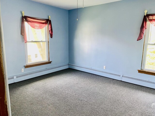 empty room with baseboards and carpet