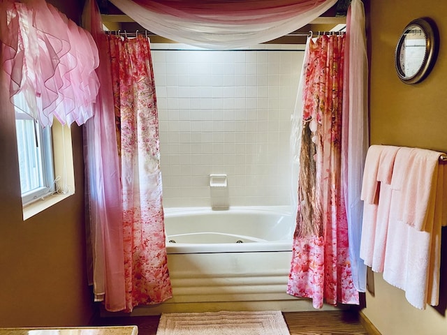 bathroom featuring shower / bath combination with curtain and wood finished floors