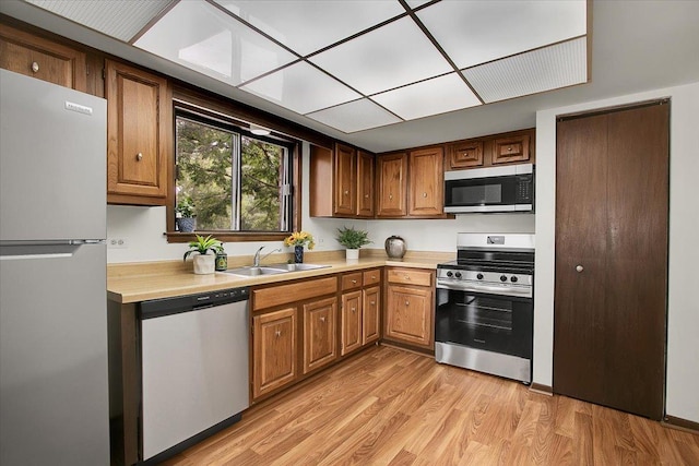 9178 S Rd E Unit D, Palos Hills, IL 60465 - kitchen featuring stainless steel appliances, light countertops, light wood-style floors, and brown cabinetry