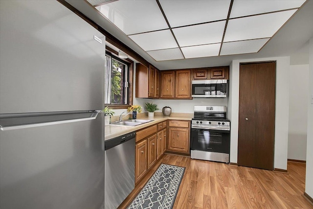 9178 S Rd E Unit D, Palos Hills, IL 60465 - kitchen featuring stainless steel appliances, light countertops, light wood-style floors, and brown cabinets