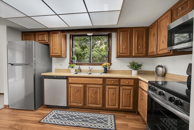 9178 S Rd E Unit D, Palos Hills, IL 60465 - kitchen featuring stainless steel appliances, brown cabinets, light countertops, and light wood-type flooring