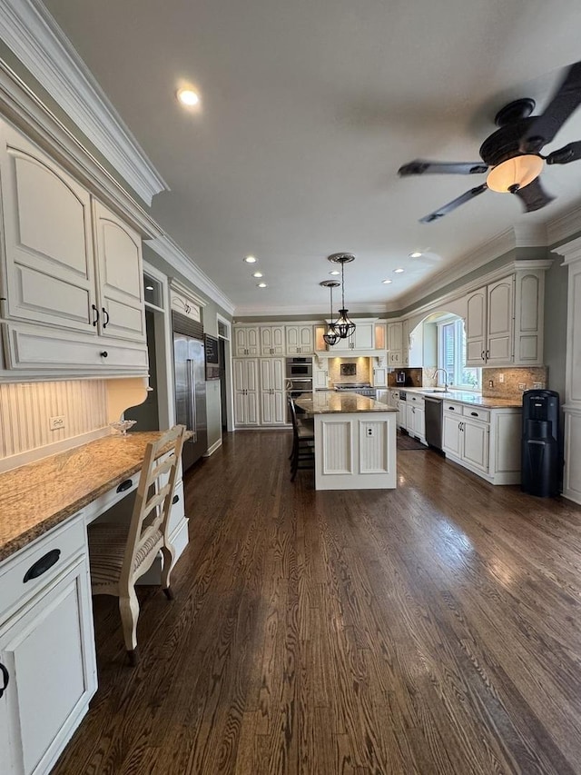 kitchen with crown molding, appliances with stainless steel finishes, decorative backsplash, and dark wood-type flooring