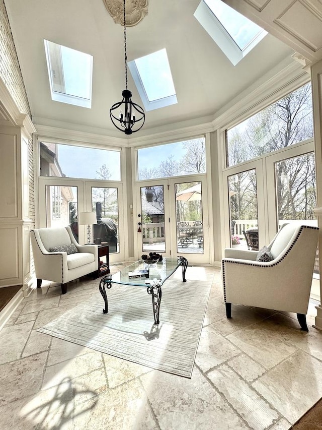 sunroom featuring a skylight, a chandelier, plenty of natural light, and french doors