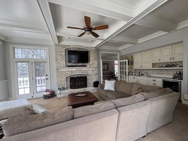 living area with ornamental molding, bar area, and beamed ceiling