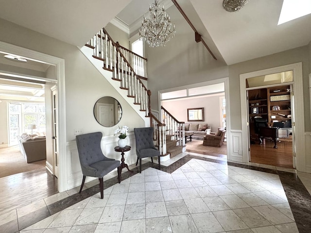 3009 Fox Glen Ct, Saint Charles, IL 60174 - foyer with stairs, a decorative wall, a wainscoted wall, ornamental molding, and an inviting chandelier