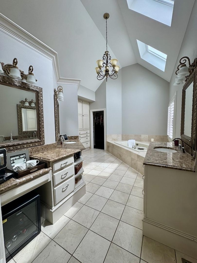 full bath with vanity, lofted ceiling with skylight, tile patterned floors, a bath, and a notable chandelier