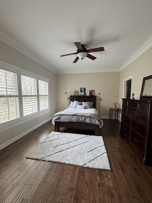 bedroom featuring crown molding, baseboards, and dark wood finished floors