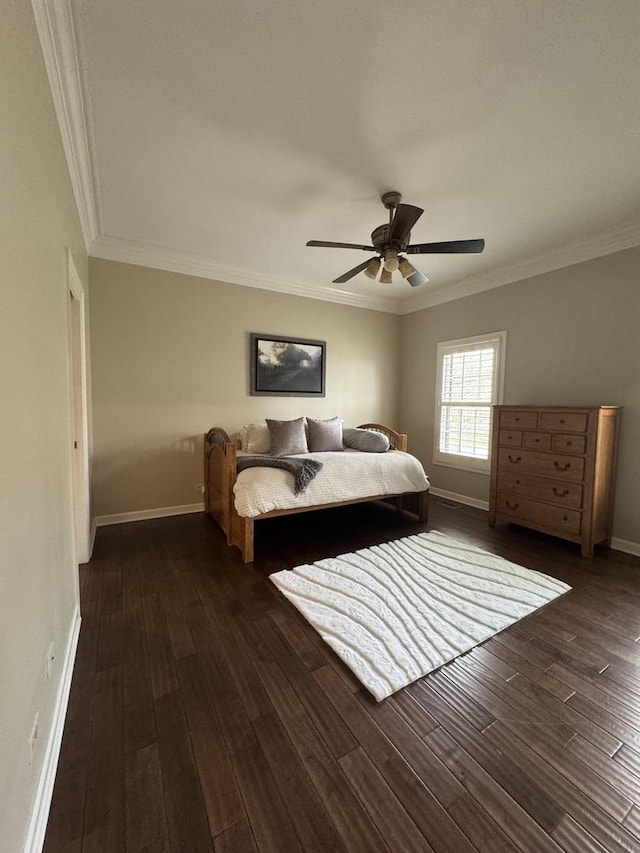 bedroom with baseboards, ornamental molding, and wood finished floors